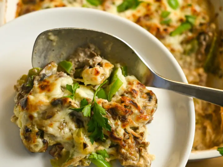 gluten-free Philly cheesesteak casserole being served on a small white plate