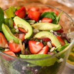 keto-friendly strawberry salad in a clear salad bowl