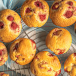 keto raspberry coconut flour muffins cooling on a baking rack