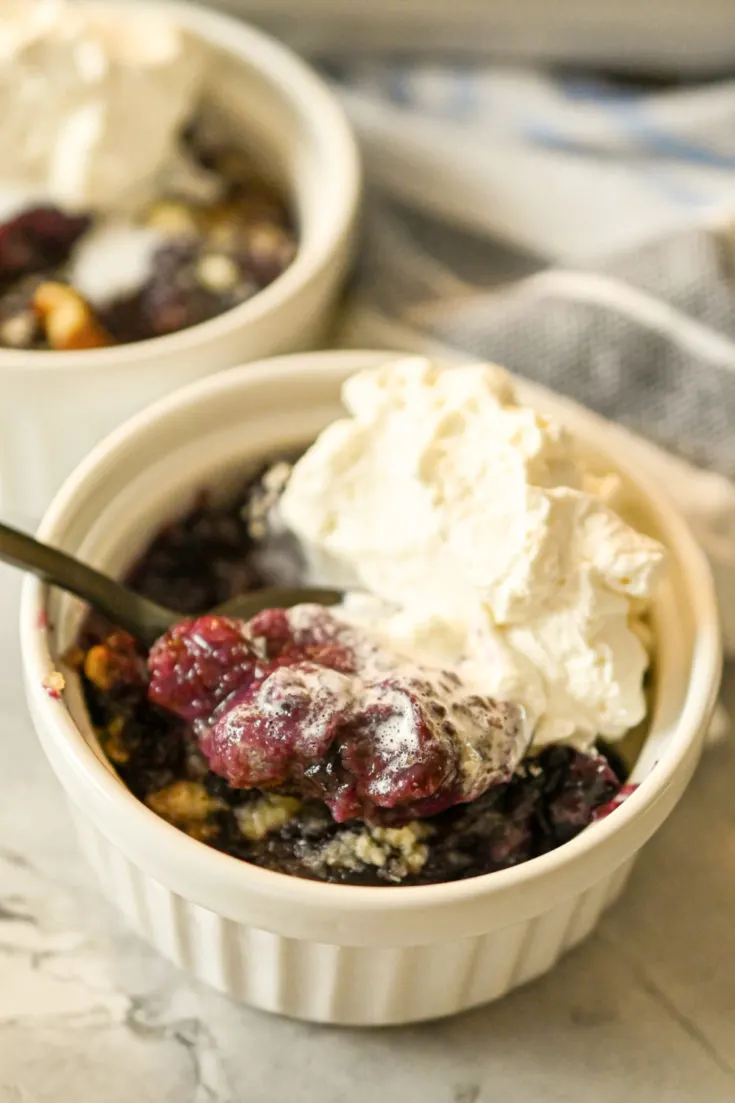 low carb blackberry cobbler served in white ramekins topped with keto vanilla ice cream