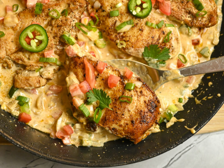 keto creamy jalapeño chicken cooked in a large skillet and ready to serve