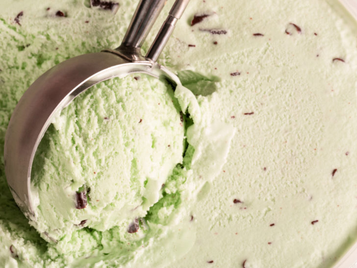 keto chocolate chip mint ice cream being scooped from an ice cream maker