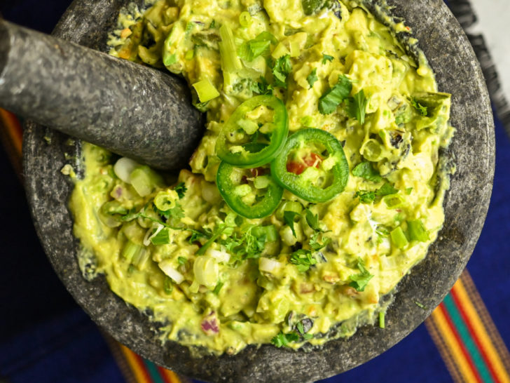 Spicy Guacamole Recipe made and served in a large mortar and pestle