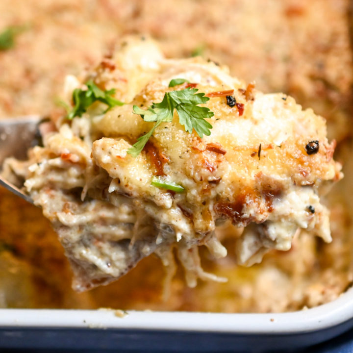 keto cordon bleu lasagna scooped out of a white rectangle baking dish