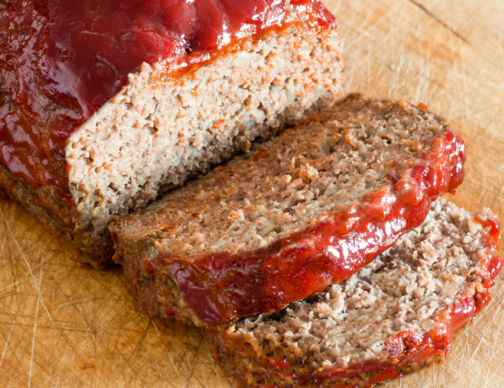 keto-friendly meatloaf sliced on a wood cutting board