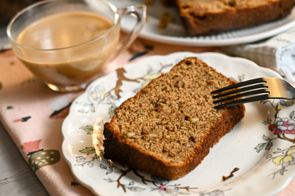 a slice of keto banana bread sliced and served on a vintage plate