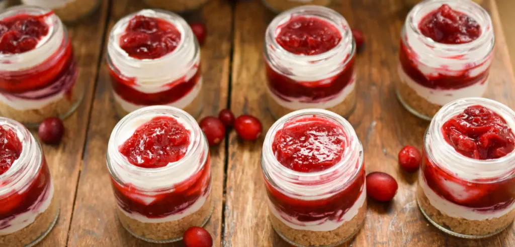 Keto no bake cranberry cheesecakes in small mason jars