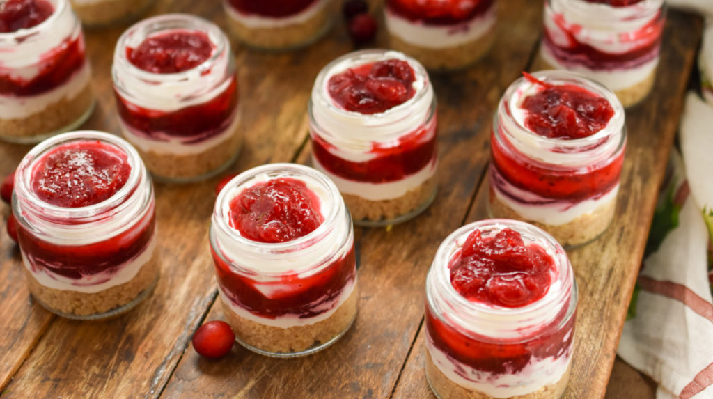 Keto no bake cranberry cheesecakes in small mason jars