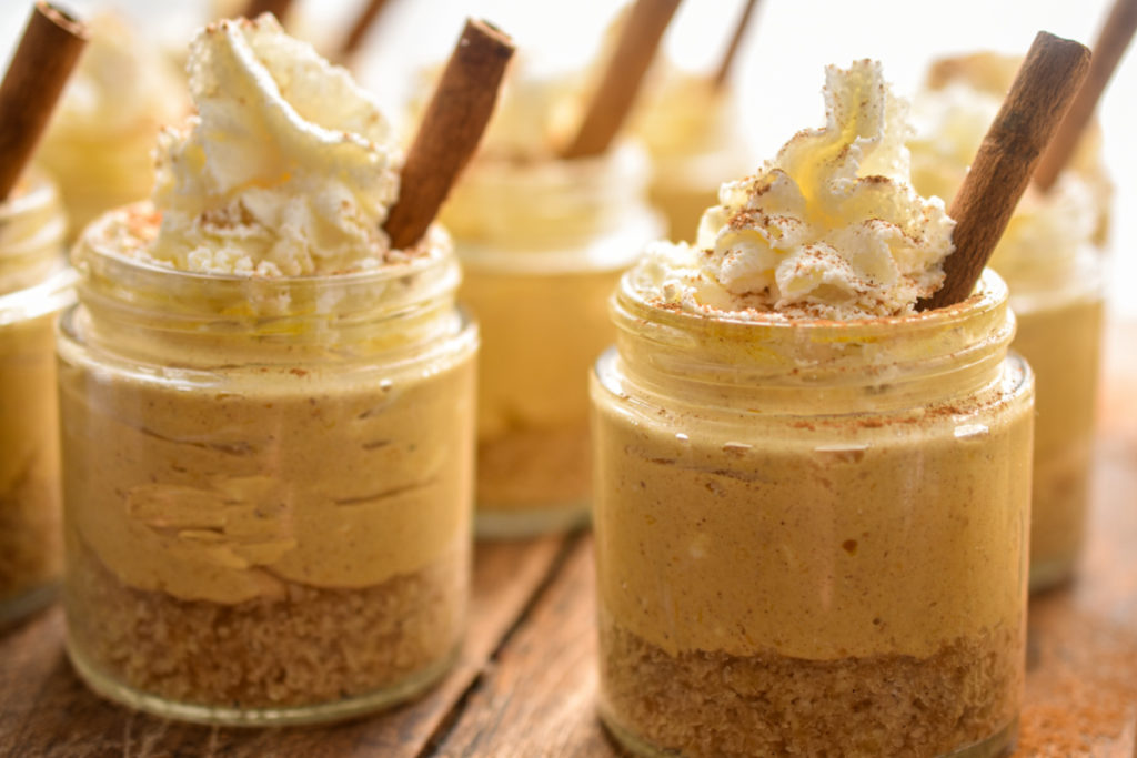 close up image of keto no-bake pumpkin cheesecakes made in small mason jars