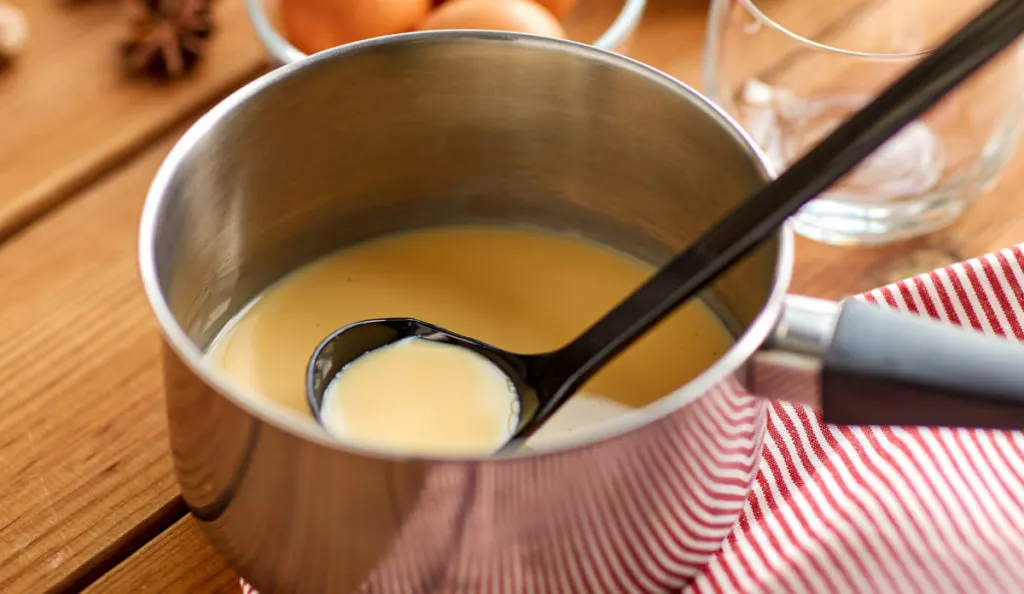 keto eggnog in a small pot with black ladle