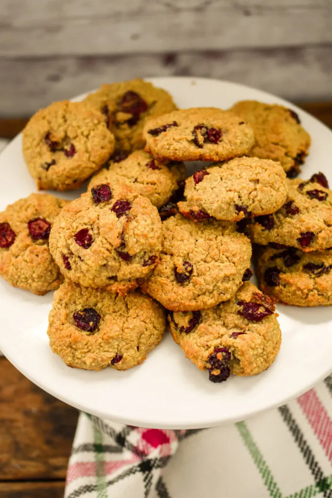 keto oatmeal cranberry cookies stacked on white stand