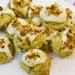 keto pistachio cookies on a white cake stand