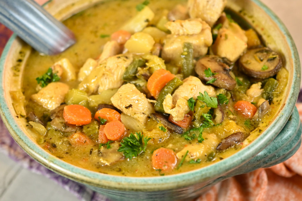 Keto chicken stew served in a clay teal pot