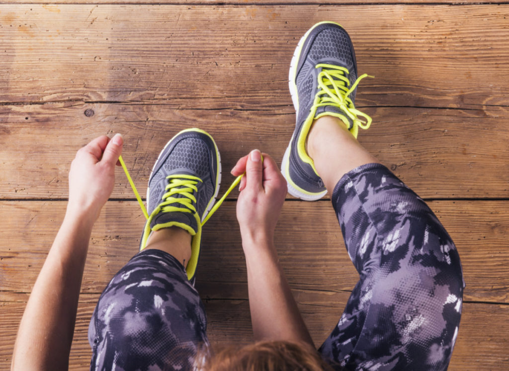 picture of a girl lacing her sneakers ready to exercise