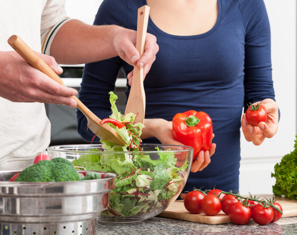 keto-friendly salad being made by a couple