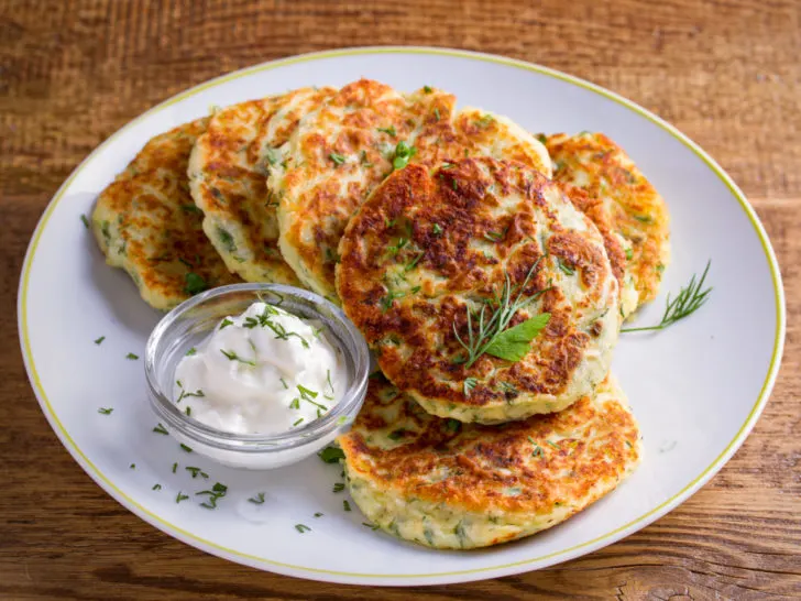 Gluten-free cauliflower fritters plated with a side of ranch dressing