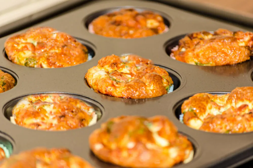 keto egg muffins baked in a non-stick pan with paper liners