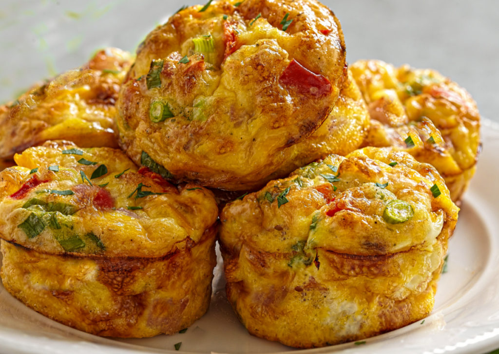 keto-friendly egg muffins stacked on a white plate