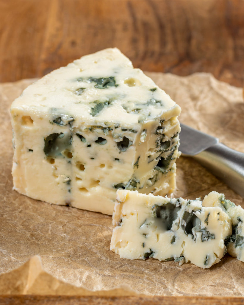 wedge of blue cheese on a piece of parchment paper