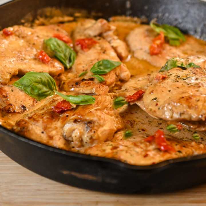 keto Tuscan chicken cooked in a cast iron skilled