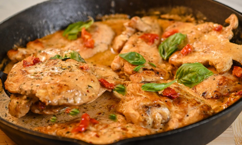 keto Tuscan chicken cooked in a cast iron skillet