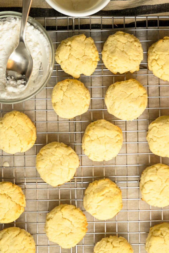 keto almond flour cream cheese cookies getting ready to be iced with an Amaretti sugar-free icing