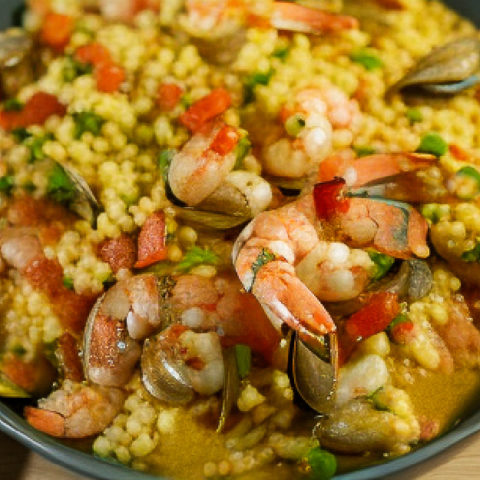 low carb paella served in a green shallow plate