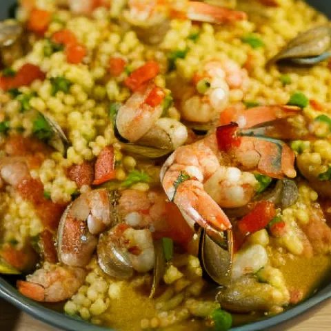 low carb paella served in a green shallow plate