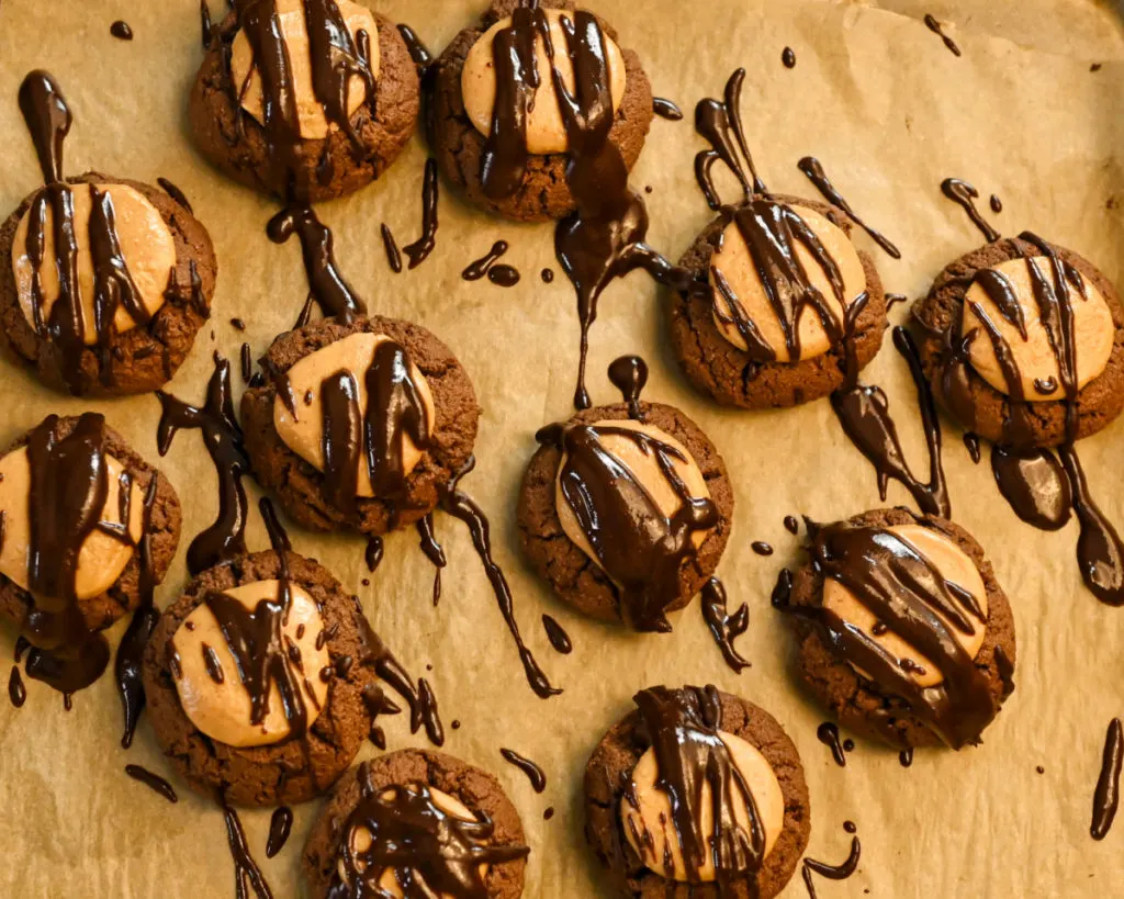 keto buckeye cookies with topped with a drizzle of chocolate icing
