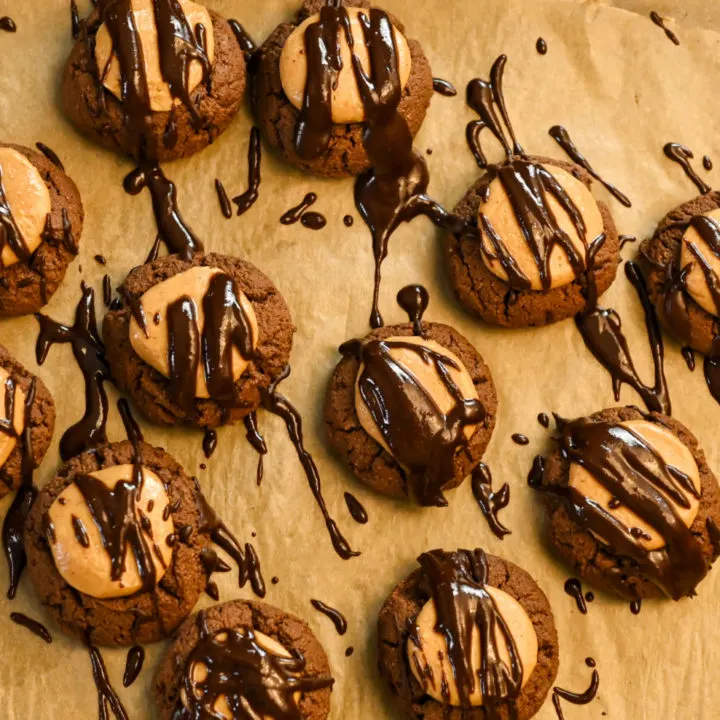 keto buckeye cookies with topped with a drizzle of chocolate icing