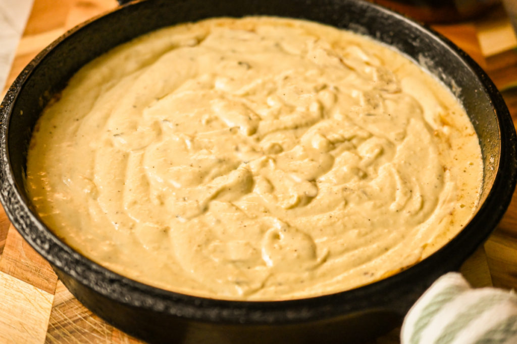 keto olive oil cake ready to be baked in a cast-iron skillet