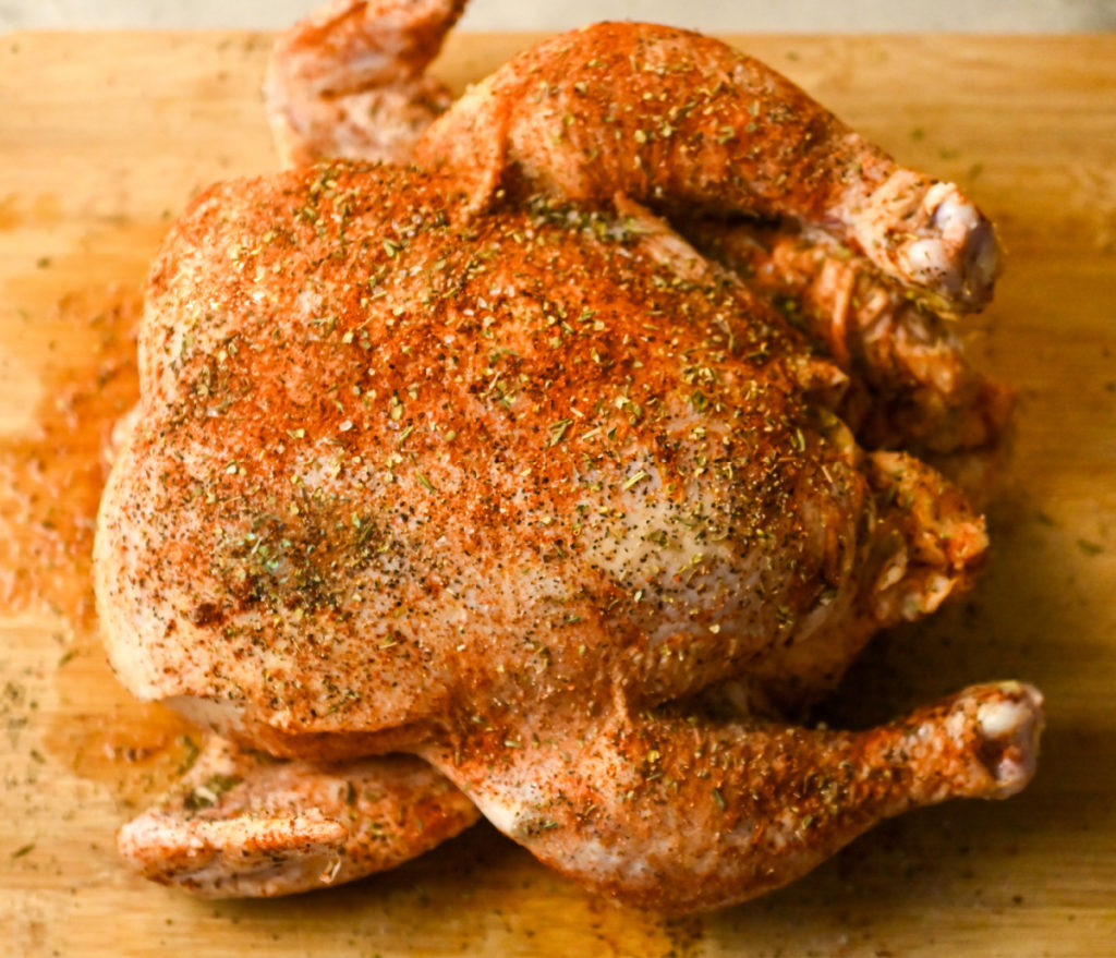 whole cajun chicken seasoned and ready to add to a crockpot