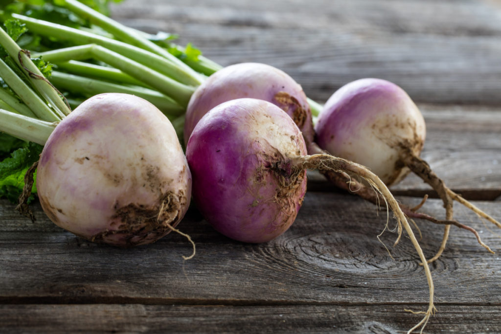 fresh turnips on a wooden board