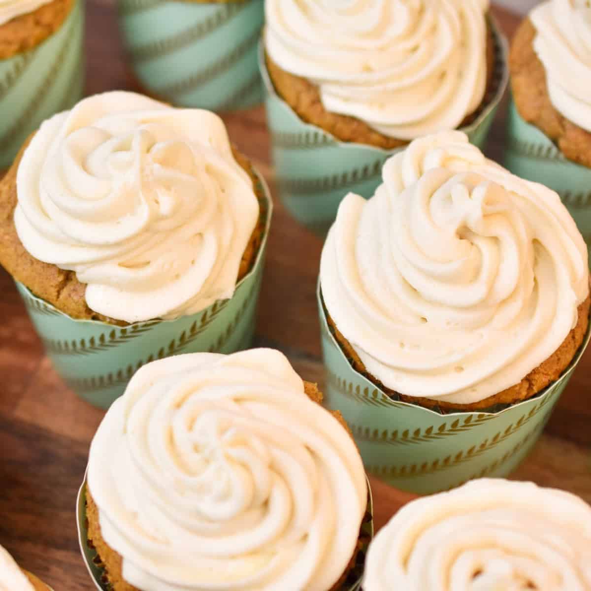 keto carrot cake cupcakes on a wood cake stand 1200