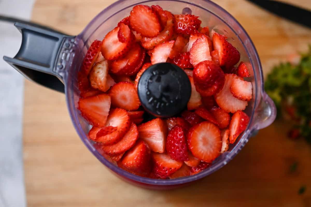 fresh sliced strawberries in a food processor