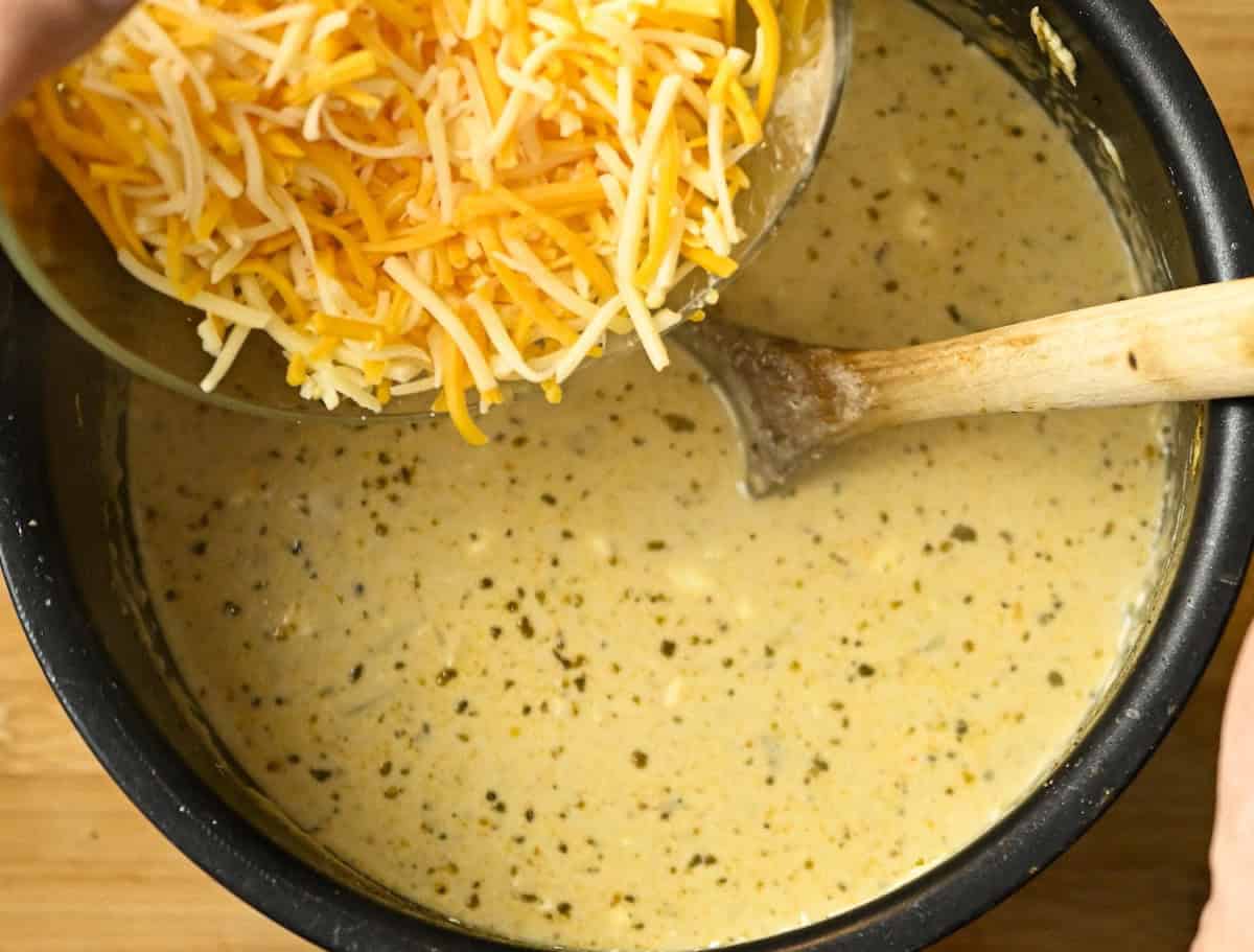 shredded cheese being added to carnivore chicken chili