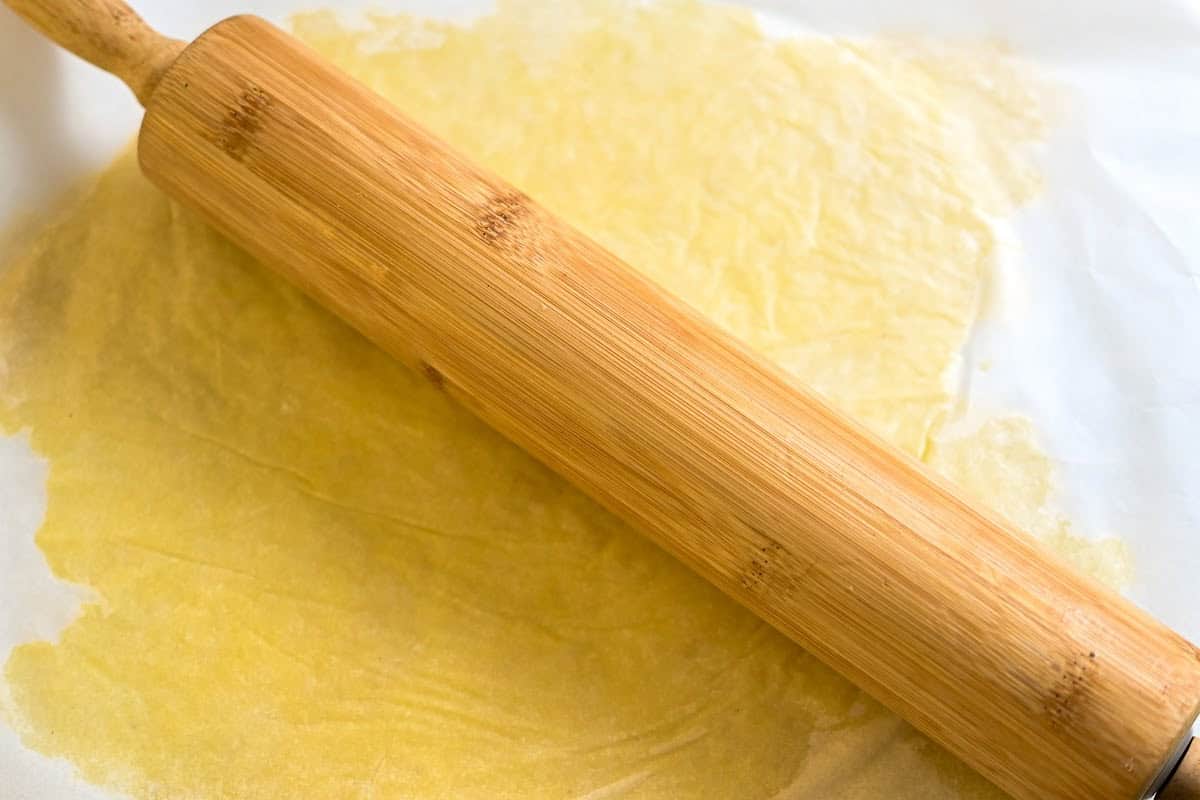 low-carb pie crust rolled between two parchment papers