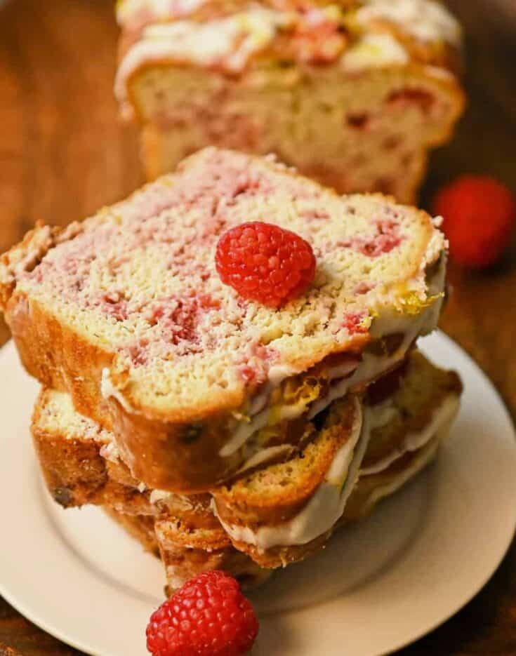 keto raspberry bread slices stacked on a plate