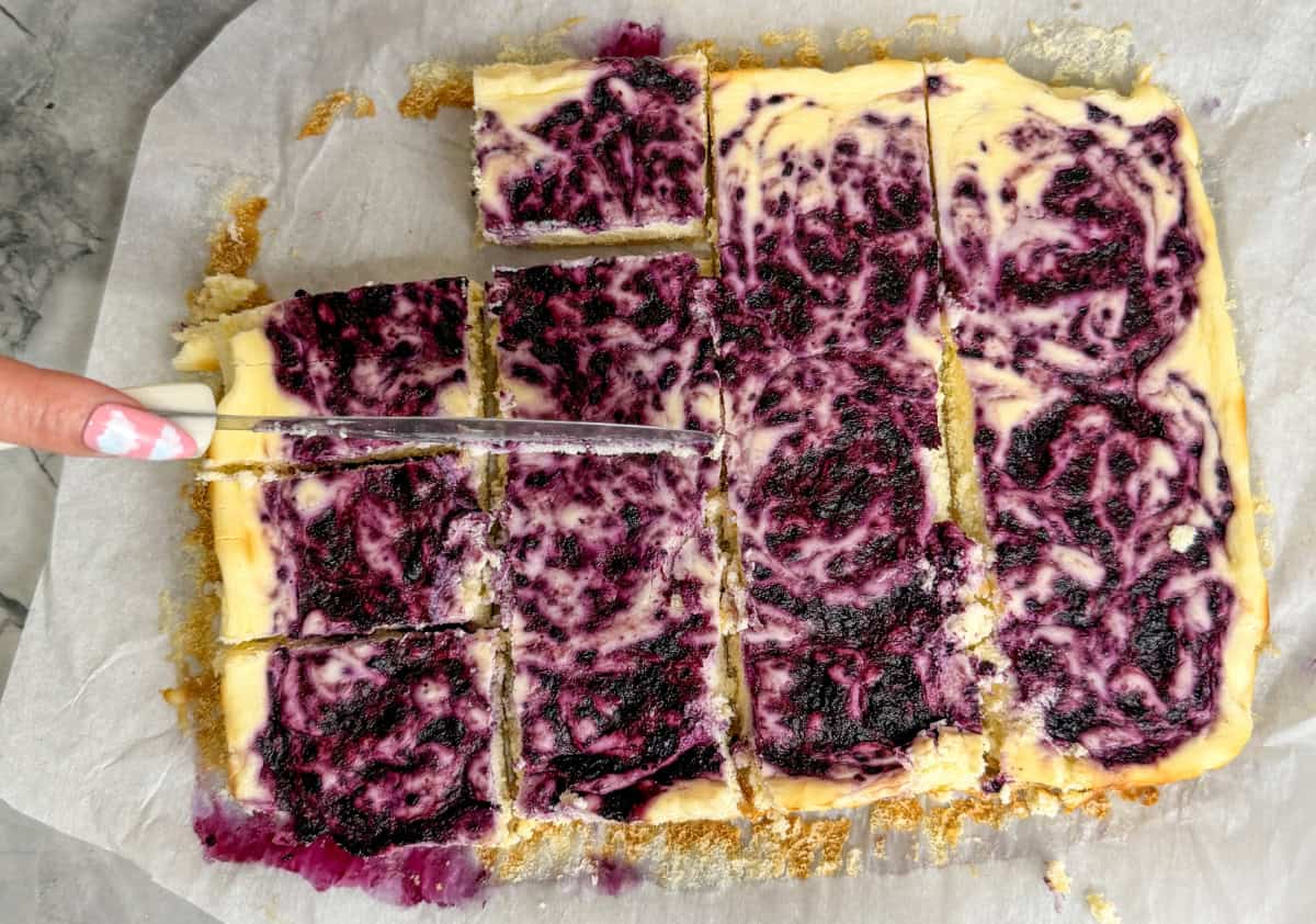 Keto Blueberry Cheesecake Bars Being Sliced