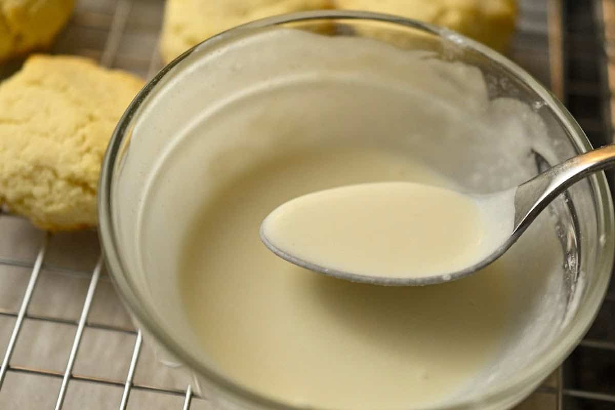 keto eggnog cookies being topped with sugar-free eggnog icing